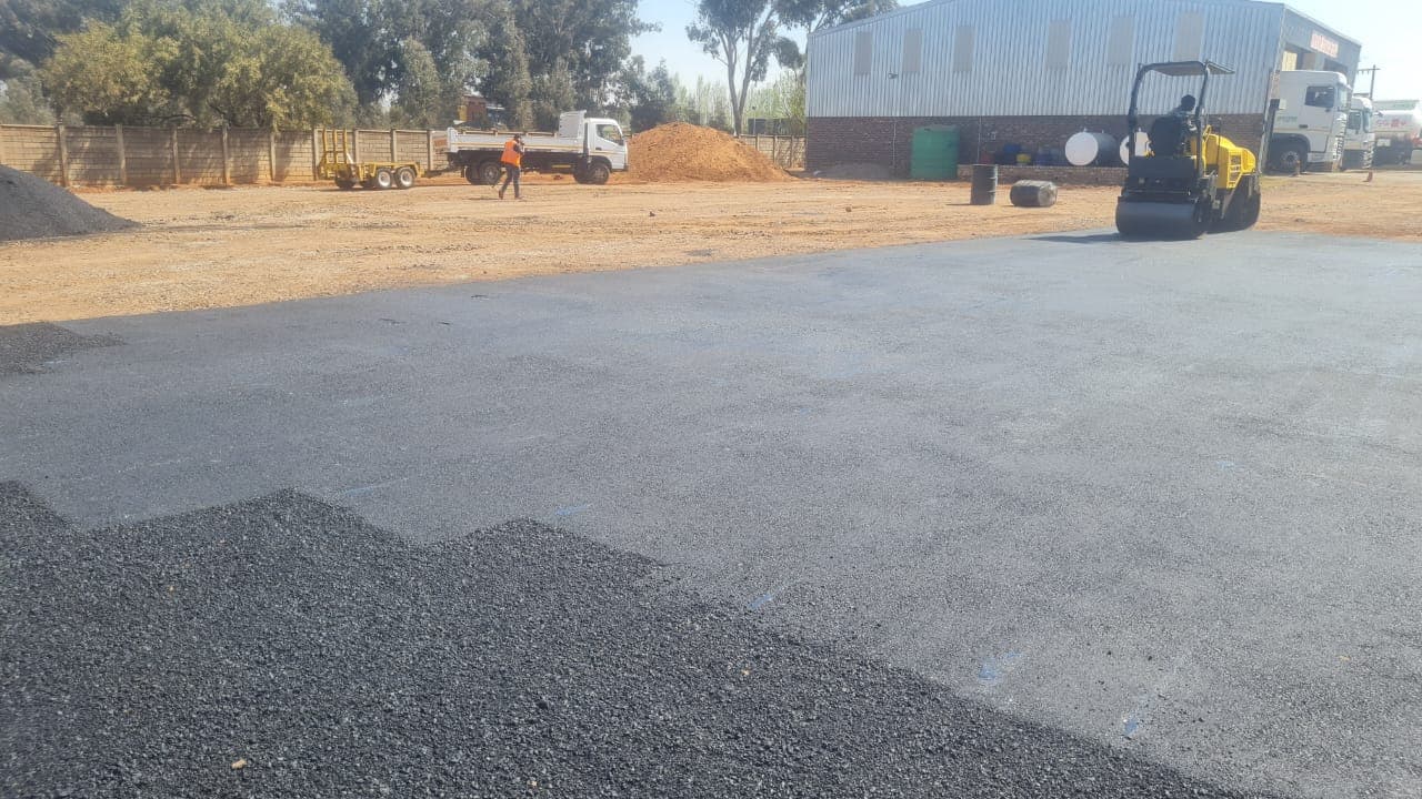 Asphalt paving machine laying down new asphalt